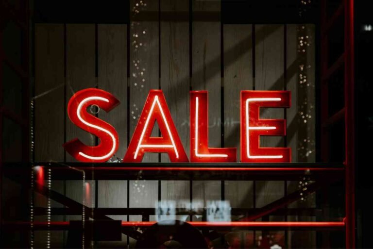 Red neon SALE sign in a shop window for product descriptions that sell