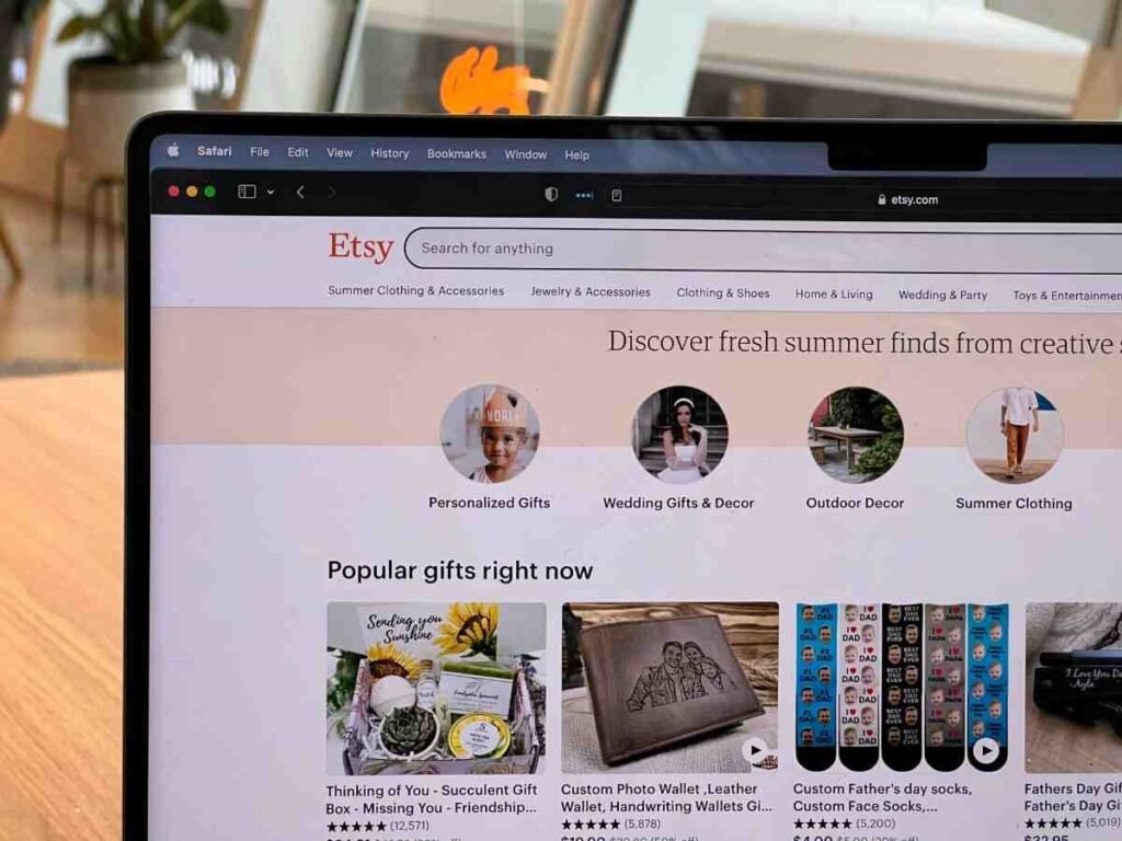 Fashion dropshipping how to start: laptop screen showing Etsy marketplace homepage with clothing and gift categories