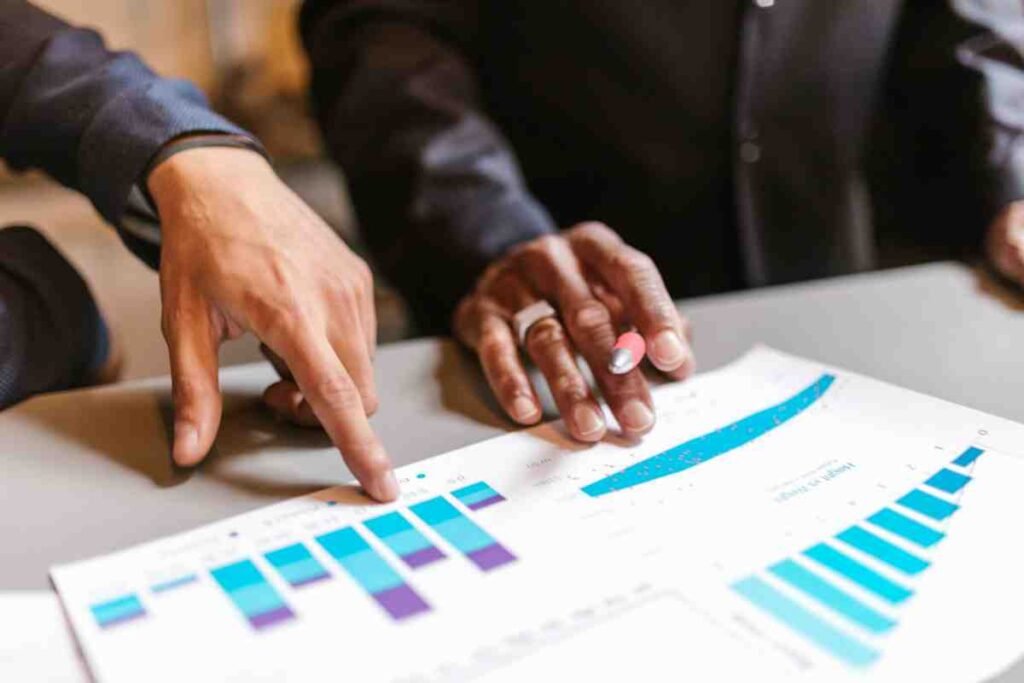 Team reviewing printed data charts and graphs – Competitor SEO Analysis Guide