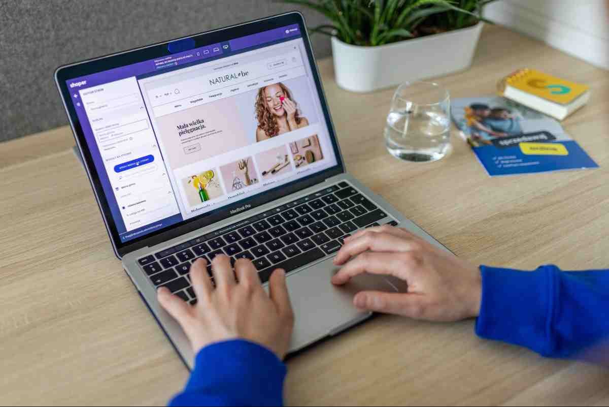 Shopify vs Etsy: person building an online store on a laptop using an e-commerce page editor